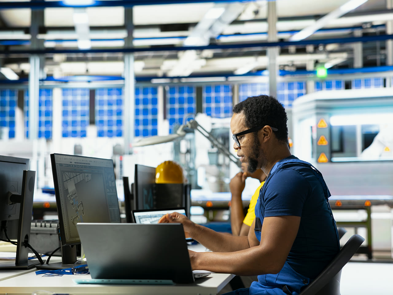Engineer working on CAD at a design workstation