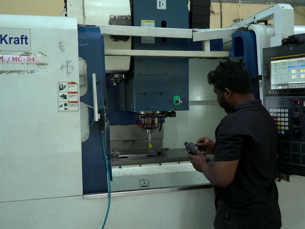 Machinist operating a CNC machining centre