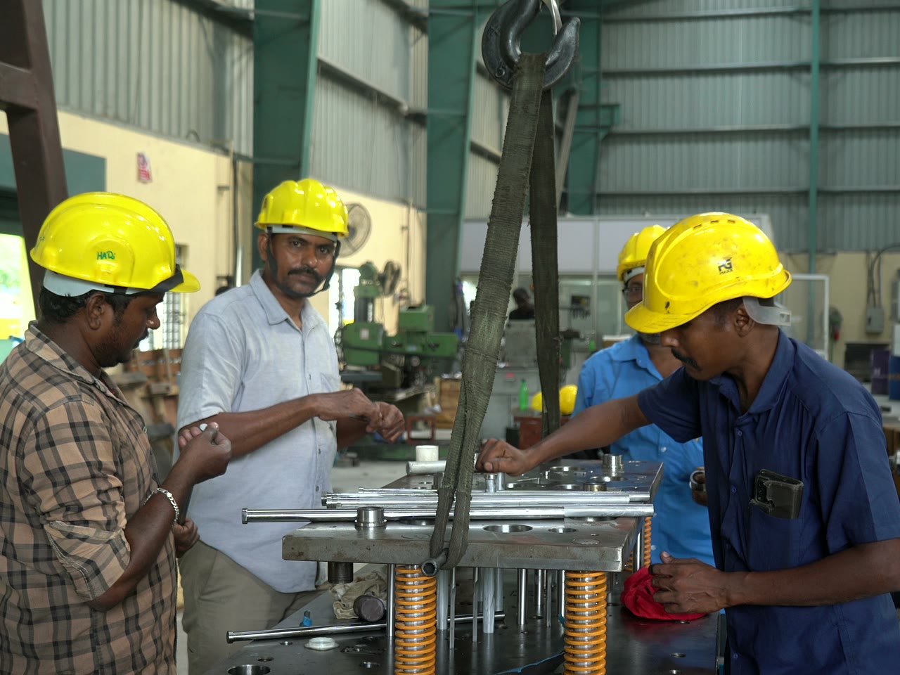Team assembling a press die together