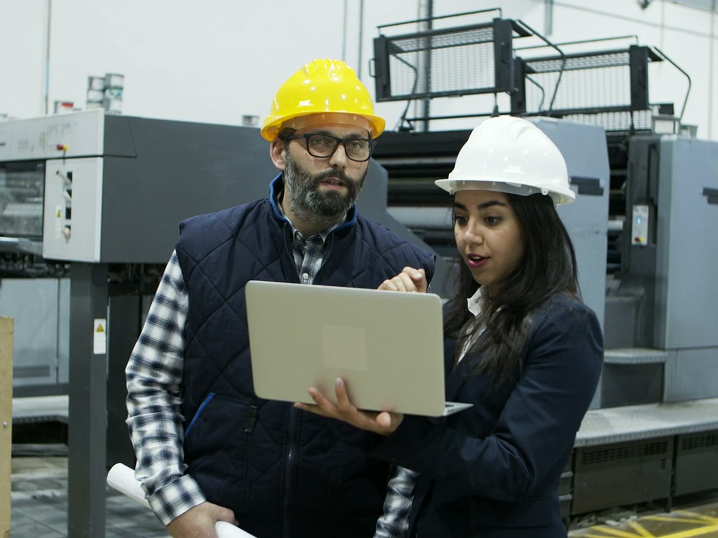 Two engineers reviewing a design on a laptop together