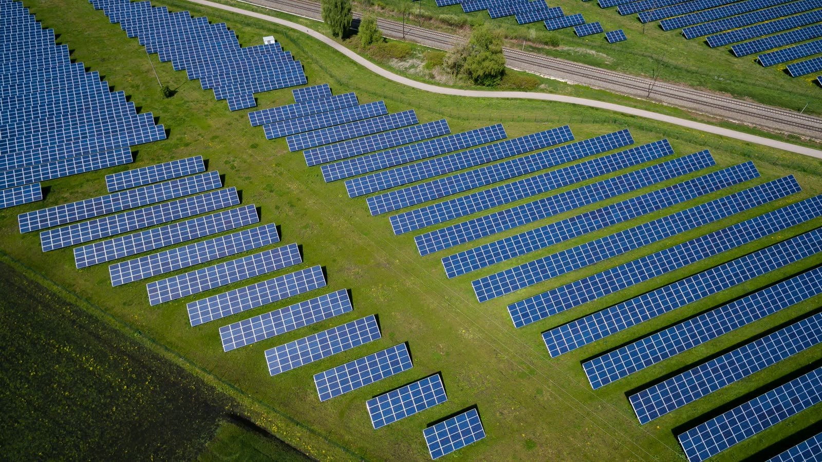Aerial view of a solar farm between green fields